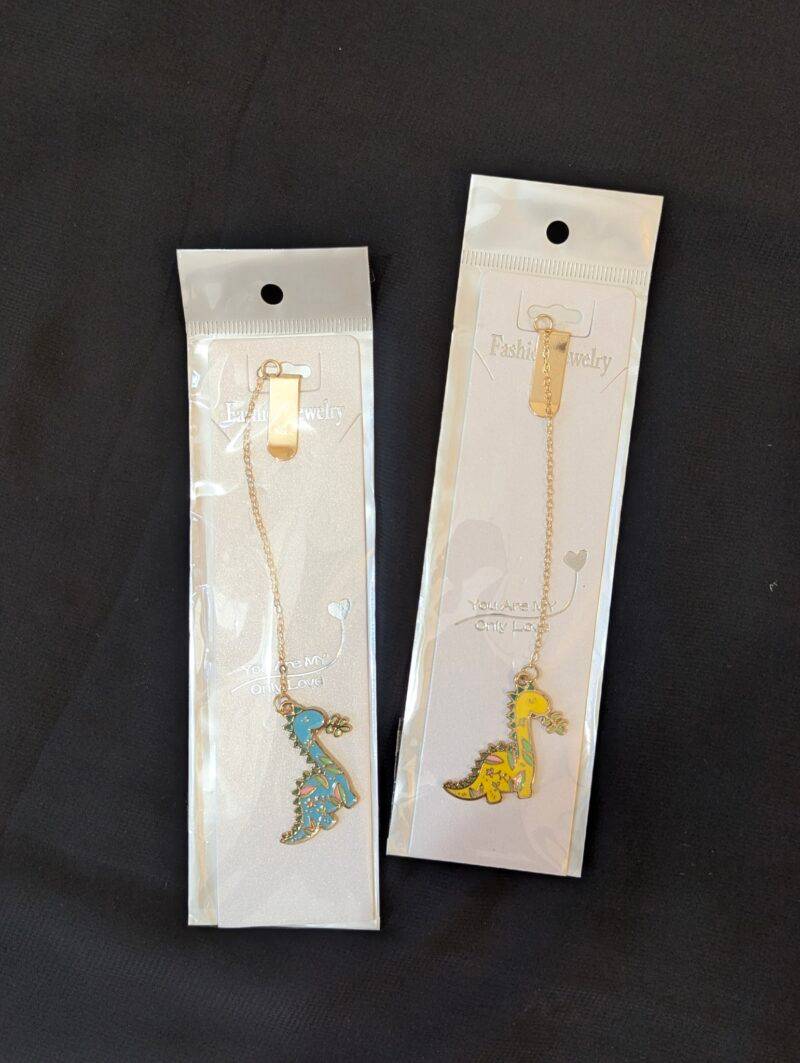 Product image of all the metal pendant bookmarks from Dino series, that's sold by Plumbum Stationaries BD.